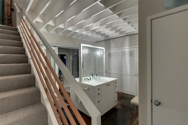 stairway with sink and a barn door