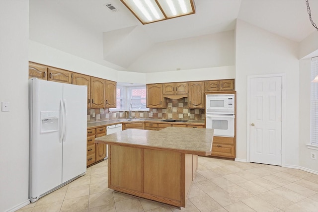 kitchen featuring white appliances, a kitchen island, tasteful backsplash, sink, and high vaulted ceiling