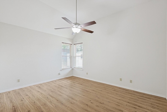 empty room featuring vaulted ceiling, ceiling fan, and light hardwood / wood-style flooring