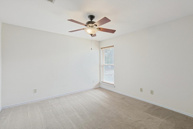 empty room featuring ceiling fan and light carpet