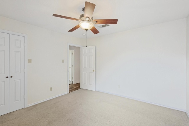 unfurnished bedroom featuring a closet, ceiling fan, and carpet flooring