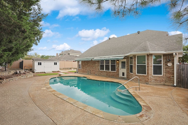 view of swimming pool featuring a patio area and a storage unit