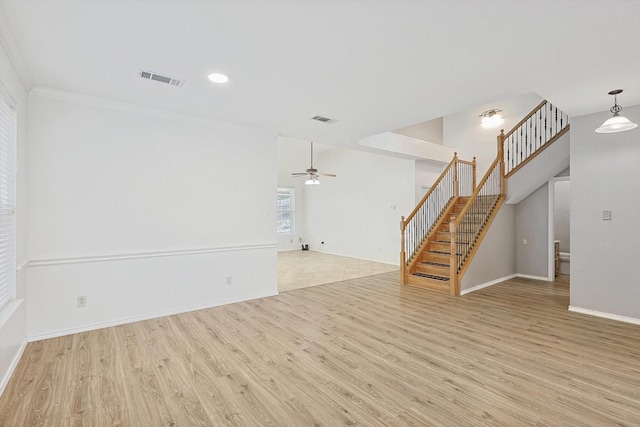 unfurnished living room featuring light hardwood / wood-style floors, ceiling fan, and ornamental molding