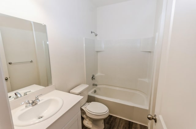 full bathroom with tub / shower combination, hardwood / wood-style flooring, toilet, and vanity