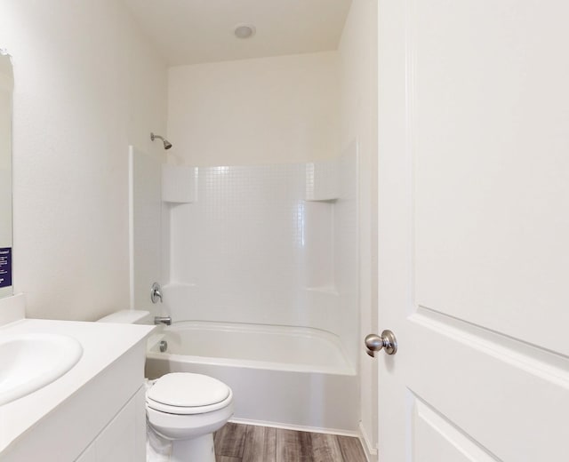 full bathroom with vanity, toilet, hardwood / wood-style floors, and bathing tub / shower combination