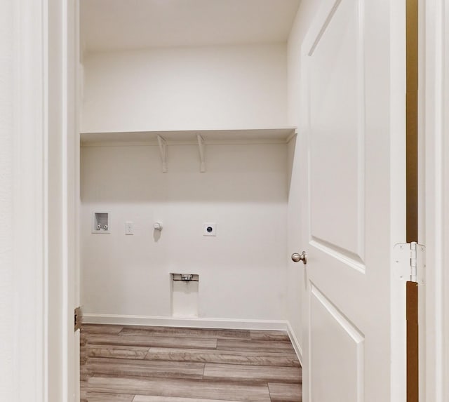 clothes washing area with electric dryer hookup, hardwood / wood-style floors, washer hookup, and hookup for a gas dryer