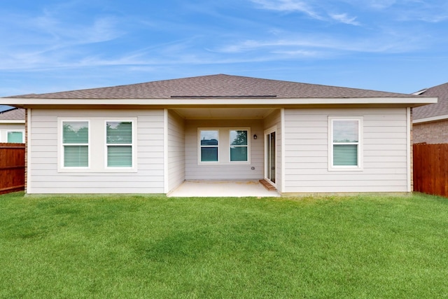 rear view of house with a patio and a lawn