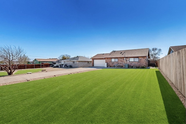 ranch-style home with a garage and a front lawn