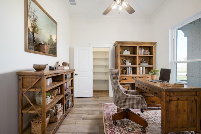 office with ceiling fan, ornamental molding, and light hardwood / wood-style floors