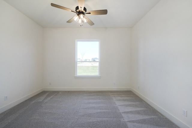 unfurnished room with ceiling fan and carpet