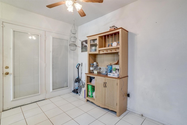 interior space featuring ceiling fan and light tile patterned floors