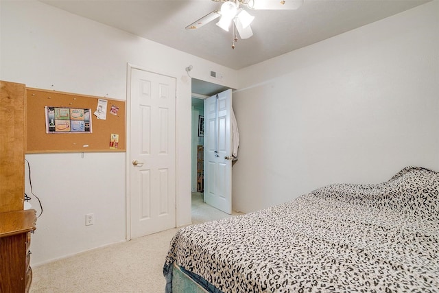 bedroom featuring ceiling fan and light carpet