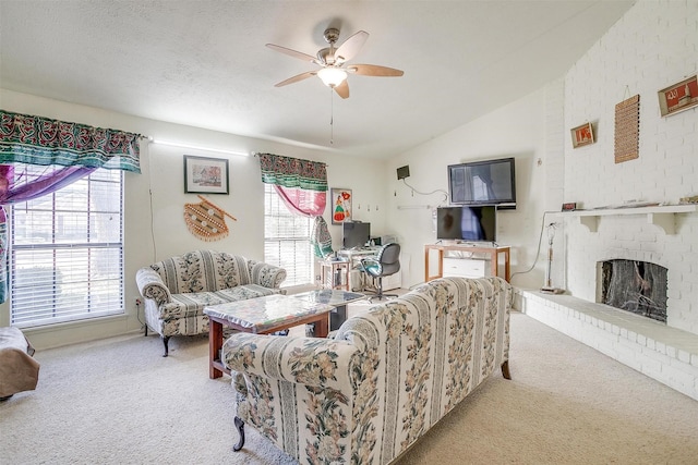 living room with ceiling fan, a fireplace, a textured ceiling, light colored carpet, and vaulted ceiling