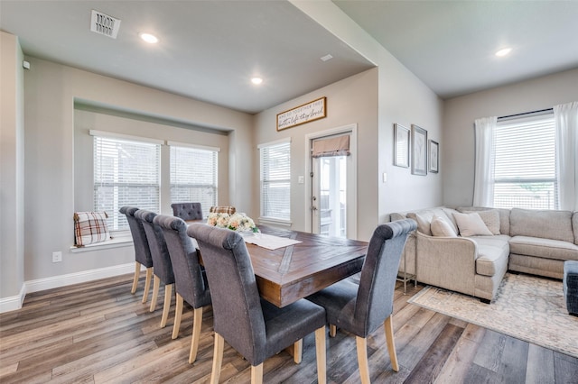 dining space with light wood-type flooring and plenty of natural light