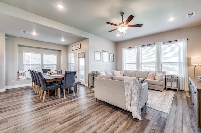 living room with ceiling fan and light hardwood / wood-style floors