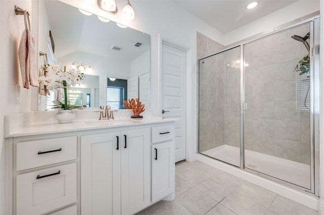 bathroom with walk in shower, vaulted ceiling, tile patterned floors, and vanity