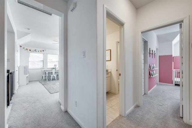 hall with light colored carpet