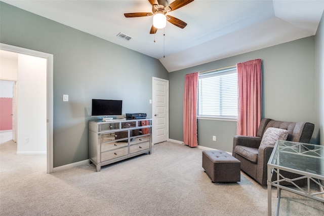 sitting room with ceiling fan, light carpet, and vaulted ceiling