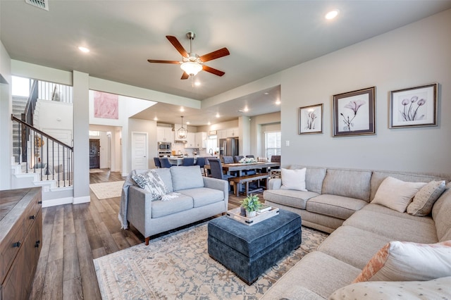 living room with ceiling fan and hardwood / wood-style floors