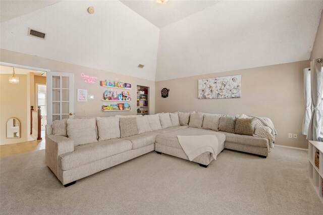 carpeted living room with a textured ceiling and vaulted ceiling