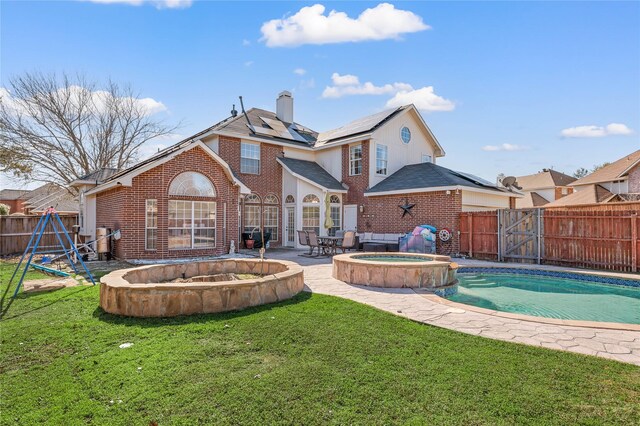 view of swimming pool featuring an in ground hot tub and a patio