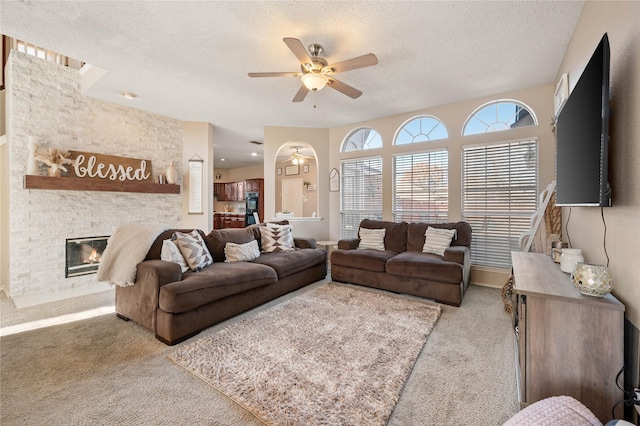 living room with ornamental molding, a textured ceiling, and carpet floors