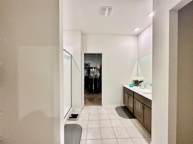 bathroom featuring a shower, vanity, and tile patterned flooring