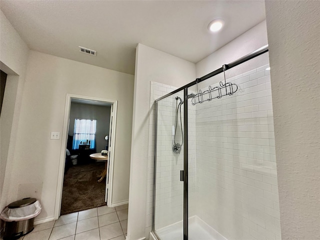 bathroom featuring tile patterned floors and an enclosed shower