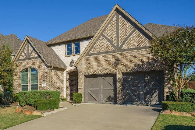 tudor-style house featuring a garage