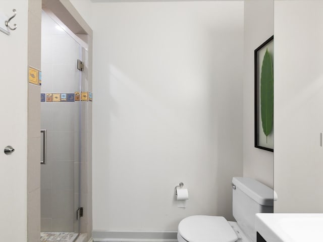 bathroom with vanity, toilet, and an enclosed shower