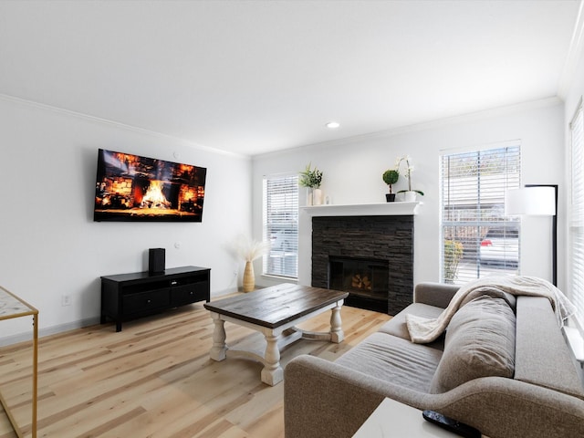 living room featuring crown molding, light hardwood / wood-style floors, and a stone fireplace