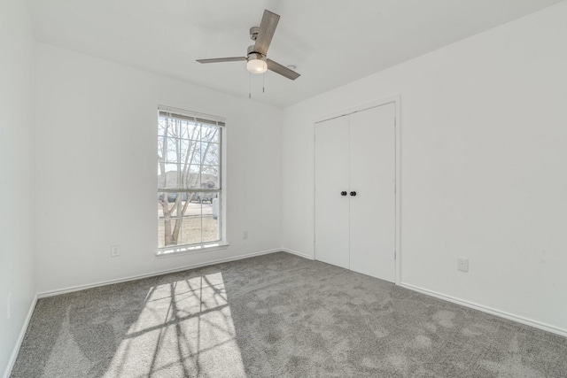 unfurnished bedroom featuring a closet, ceiling fan, and carpet floors