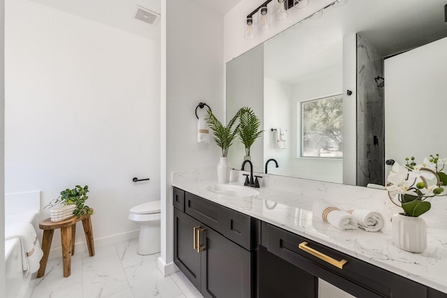 bathroom featuring vanity, toilet, and tiled shower