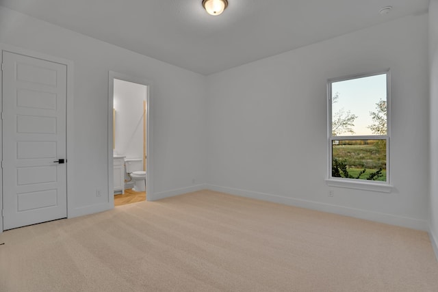 unfurnished room featuring light carpet