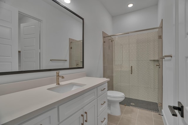 bathroom featuring an enclosed shower, vanity, toilet, and tile patterned flooring