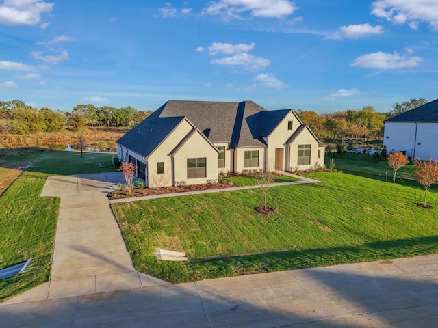 view of front of home with a garage and a front lawn