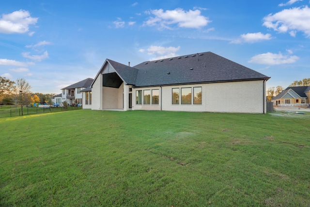 back of house with a yard