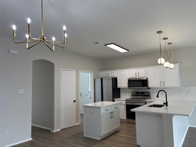 kitchen with dark wood-type flooring, a sink, visible vents, white cabinets, and appliances with stainless steel finishes