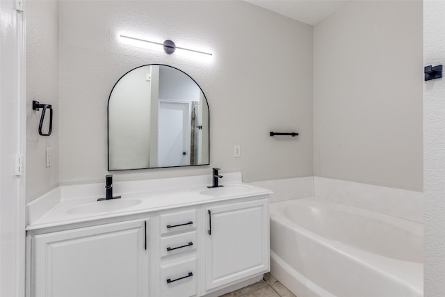 bathroom featuring double vanity, a sink, a bath, and tile patterned floors