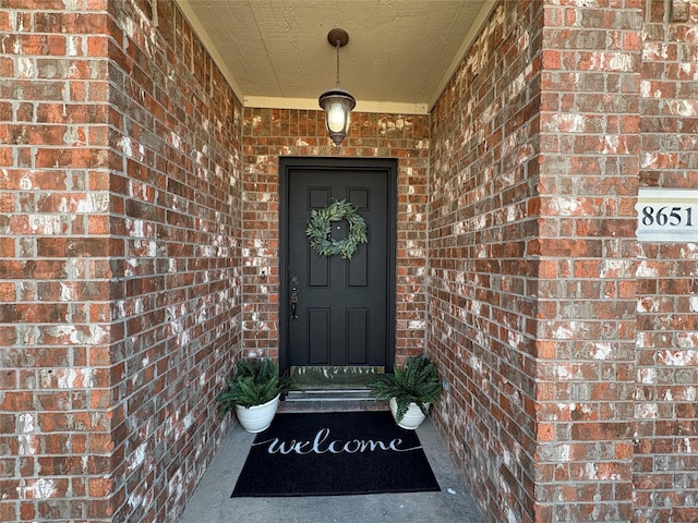 property entrance with brick siding