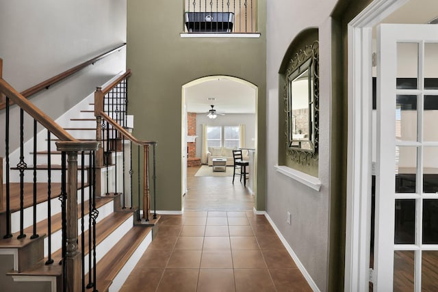 tiled entrance foyer featuring ceiling fan