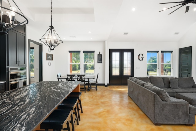 interior space featuring a tray ceiling, french doors, a wealth of natural light, and recessed lighting