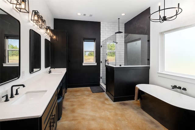 bathroom with concrete floors, a wealth of natural light, and separate shower and tub