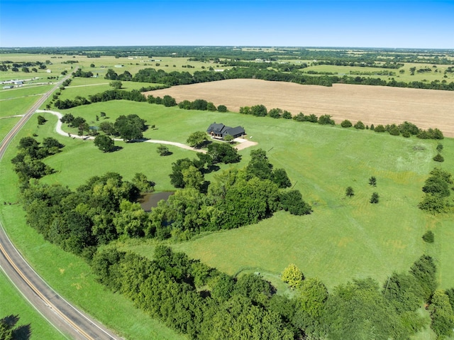 birds eye view of property with a rural view