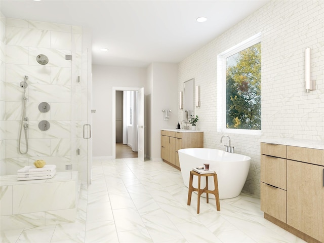 bathroom featuring plus walk in shower, vanity, and tile walls