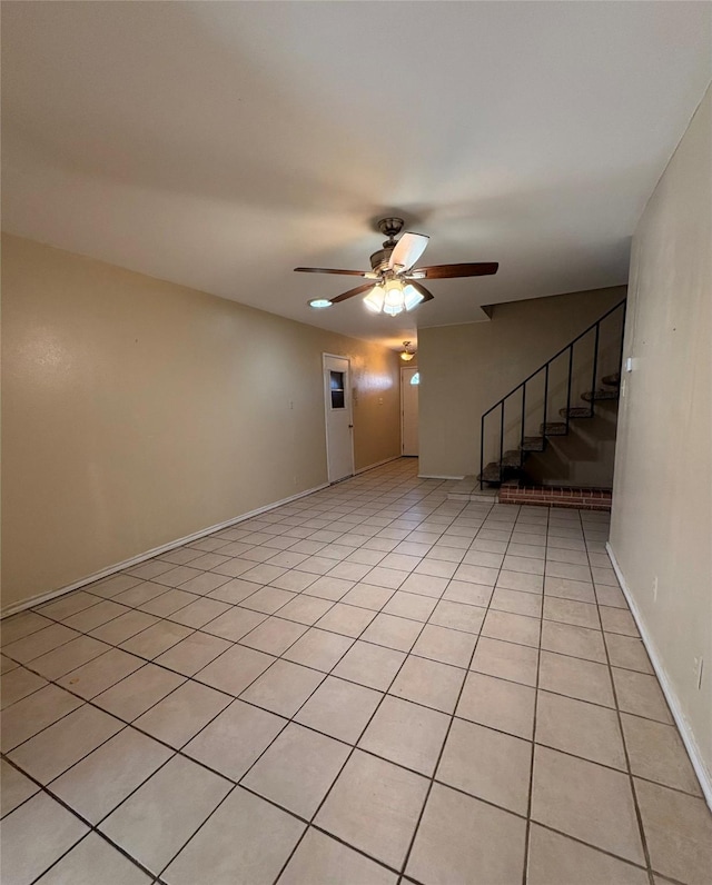 unfurnished room featuring light tile patterned floors and ceiling fan