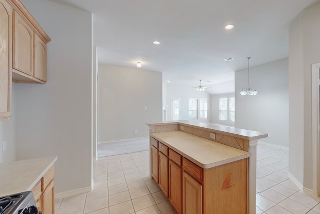 kitchen featuring a kitchen island, ceiling fan with notable chandelier, light tile patterned floors, and decorative light fixtures