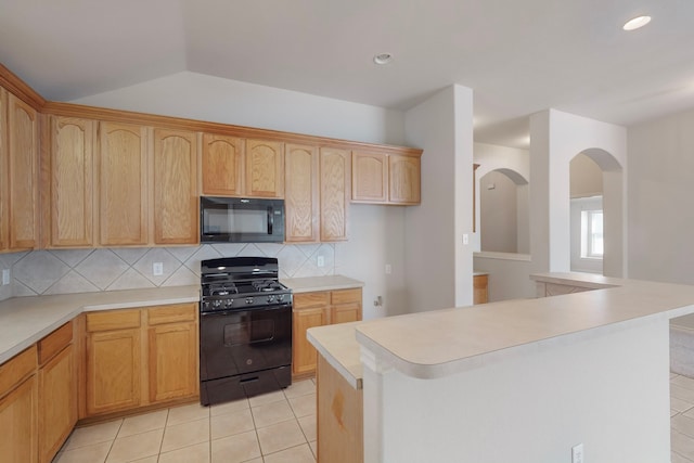 kitchen featuring black appliances, a center island, decorative backsplash, and light tile patterned flooring