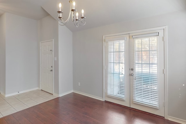 doorway featuring a chandelier, hardwood / wood-style floors, and french doors