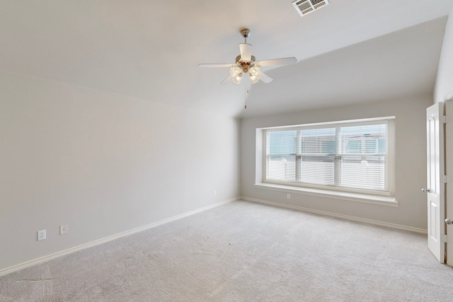 carpeted empty room with ceiling fan and vaulted ceiling